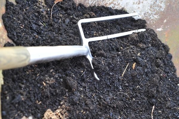 Pitch fork in dark soil