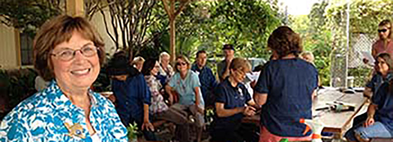 Speaker addresses an audience in an outdoor setting